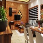 Modern living room interior design with textured accent wall, wooden TV unit and dining area by St Mary’s Interiors Kerala