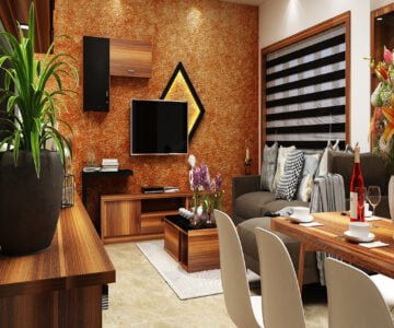Modern living room interior design with textured accent wall, wooden TV unit and dining area by St Mary’s Interiors Kerala